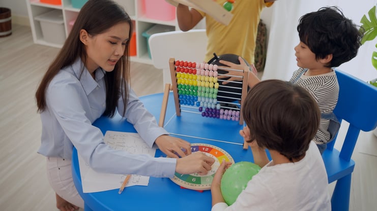preschool-teacher-with-children-study-classroom-kindergarten-back-school