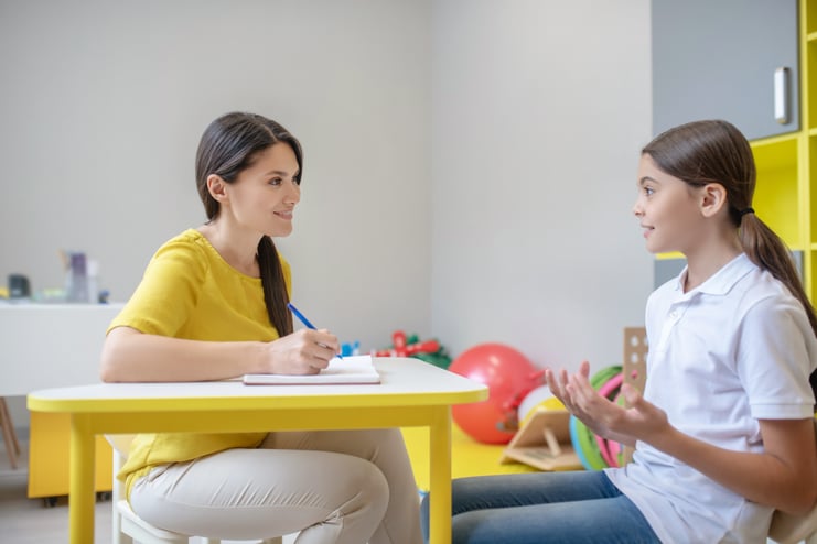 serious-talking-girl-white-tshirt-jeans-smiling-attentive-woman-psychologist-office